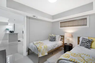 a white bedroom with two beds and a window at Life Is Gucci! Gorgeous WATER VIEWS Miami Condo! in Miami