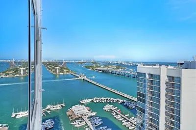 a view of a marina from the top of a building at Champagne & Ice! Water Views, 2 Private Balconies! in Miami