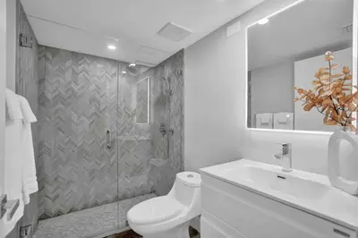 a bathroom with a shower and a toilet and a sink at Big Energy! Water Views and Newly Renovated! in Miami