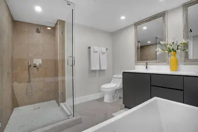 a bathroom with a glass shower and a toilet at Visions! Water and Miami Skyline VIews! Brand New in Miami