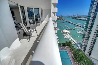 a balcony with chairs and a view of a harbor at Visions! Water and Miami Skyline VIews! Brand New in Miami