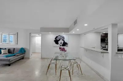 a living room with a glass table and a couch at Hello Gorgeous! Water & City Skyline Views! in Miami