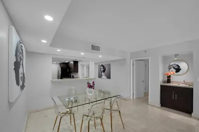 a dining room with a glass table and chairs at Hello Gorgeous! Water & City Skyline Views! in Miami