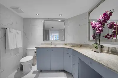 a bathroom with a sink and a toilet and a mirror at Hello Gorgeous! Water & City Skyline Views! in Miami