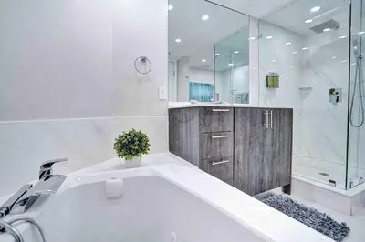 a white bathroom with a tub and a shower at Summer Retreat! Water and City Views! in Miami