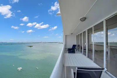 a balcony of a house with a view of the water at Velvet Sky! Water & Park Views! in Miami