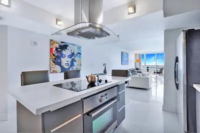 a kitchen with a white counter top and a refrigerator at Spectacular! Penthouse with Direct Water Views! in Miami