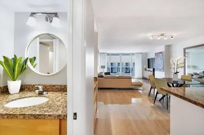 a bathroom with a sink and a living room at Day Dreamer! Water & Miami City Views! in Miami