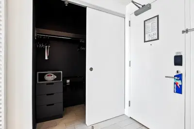 a door leading into a kitchen with black walls at Oceanview Luxury, Resort Access, Sleeps 6 2BR 2BA - Vista Mar by HomeStakes Stays in Fort Lauderdale
