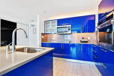 a kitchen with blue cabinets and a sink at Oceanview Luxury, Resort Access, Sleeps 6 2BR 2BA - Vista Mar by HomeStakes Stays in Fort Lauderdale