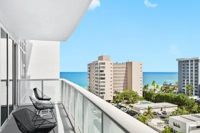 a balcony with two chairs and a view of the ocean at Oceanview Luxury, Resort Access, Sleeps 6 2BR 2BA - Vista Mar by HomeStakes Stays in Fort Lauderdale