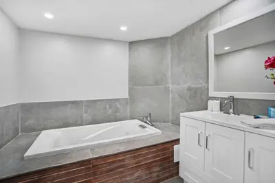 a bathroom with a bath tub and a sink at Blue Moon! In the lap of luxury and brand new! in Miami