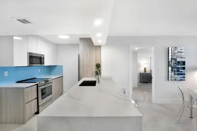 a kitchen with white counters and a stove top oven at Sweet Dreams! Renovated with Water Views in Miami