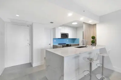 a white kitchen with a sink and a counter at Sweet Dreams! Renovated with Water Views in Miami