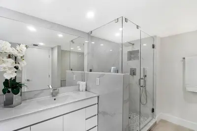 a white bathroom with a sink and a shower at Sweet Dreams! Renovated with Water Views in Miami