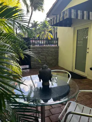 a table with a vase on top of a patio at VILLA GUILLA in Miami