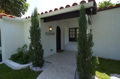 a courtyard of a house with two trees in the yard at Bars B&B South Beach Hotel in Miami Beach