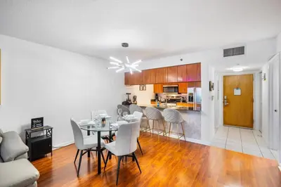 a dining room and kitchen with a table and chairs at Modern Bayview Apartment in Brickell Bay in Miami