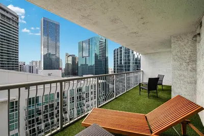 a balcony with a table and chair on a building at Modern Bayview Apartment in Brickell Bay in Miami