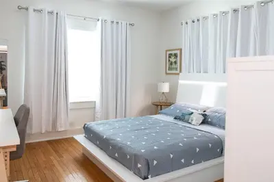 a bedroom with a bed with blue sheets and a window at Homey Little Havana Apt Centrally located Hv4 in Miami