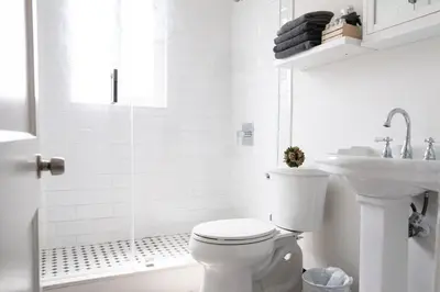 a white bathroom with a toilet and a sink at Homey Little Havana Apt Centrally located Hv4 in Miami
