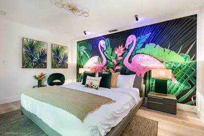 a bedroom with a large bed with pink flamingos on the wall at Flamingo's Resort -Htd Pool, 5 Bedrooms, Game Room, Baby Items , BBQ in Miami