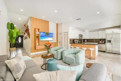 a living room with a couch and a kitchen at Flamingo's Resort -Htd Pool, 5 Bedrooms, Game Room, Baby Items , BBQ in Miami