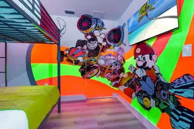 a bedroom with a colorful mural on the wall at Flamingo's Resort -Htd Pool, 5 Bedrooms, Game Room, Baby Items , BBQ in Miami