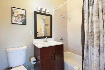 a bathroom with a sink and a toilet and a tub at Home away from home in Hollywood