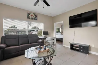 a living room with a couch and a flat screen tv at Home away from home in Hollywood