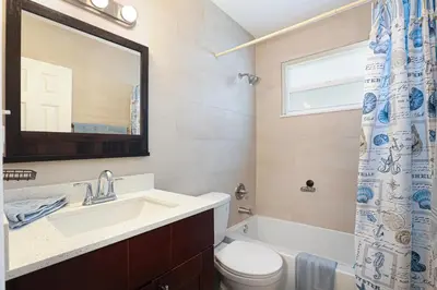 a bathroom with a sink and a toilet and a window at Home away from home in Hollywood