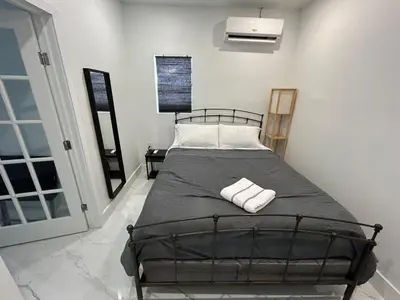 a bedroom with a bed with two towels on it at Gorgeous Private Room, near the Airport - Free parking - 02 in Miami