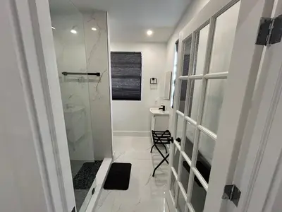 a bathroom with a walk in shower and a toilet at Gorgeous Private Room, near the Airport - Free parking - 02 in Miami