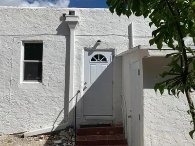 a white house with a white door and stairs at Cozy Private Room, near the Airport - Free parking - 02 in Miami