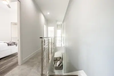 a staircase in a house with white walls at Modern 4-Bedroom Townhouse with Pool! in Miami