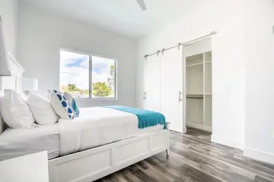 a white bedroom with a bed and a window at Modern 4-Bedroom Townhouse with Pool! in Miami