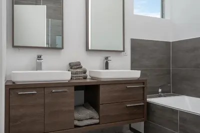 a bathroom with two sinks and a tub at Modern 4-Bedroom Townhouse with Pool! in Miami