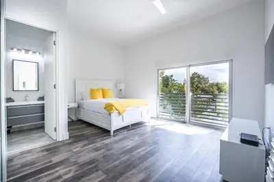 a white bedroom with a bed and a window at Modern 4-Bedroom Townhouse with Pool! in Miami