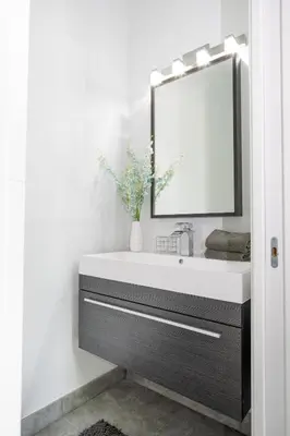 a bathroom with a sink and a mirror at Modern 4-Bedroom Townhouse with Pool! in Miami