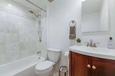 a white bathroom with a toilet and a sink at Discover Serenity in this Tranquil Miami Home in Miami