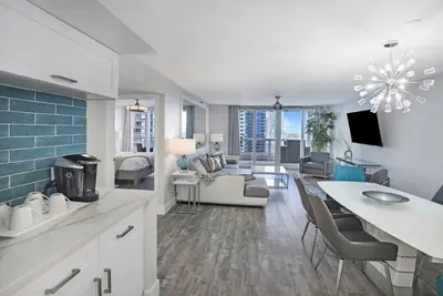 a kitchen and living room with a table and chairs at Miami Vice! Totally Renovated, Water & Park Views! in Miami