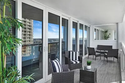 a balcony with chairs and a table on a building at Miami Vice! Totally Renovated, Water & Park Views! in Miami