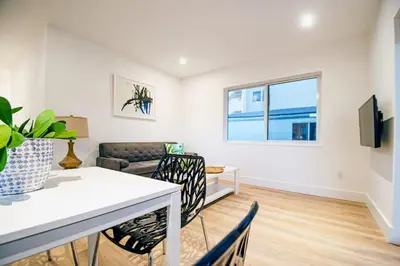 a living room with a table and chairs and a couch at Casa Canal in North Miami Beach