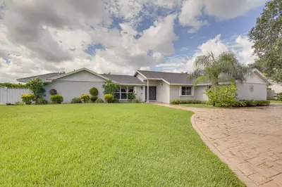 a house with a green lawn in front of it at Pet-Friendly Miami Home with Hot Tub and Pool Table in Miami