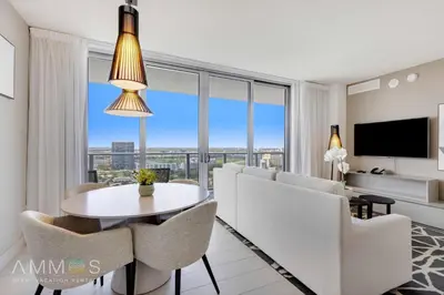a living room with a table and chairs and a television at 23rd-Floor Views • Pool Gym Beach Service in Hollywood
