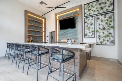 a kitchen with a bar with bar stools at 23rd-Floor Views • Pool Gym Beach Service in Hollywood