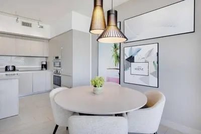 a kitchen and dining room with a table and chairs at 23rd-Floor Views • Pool Gym Beach Service in Hollywood