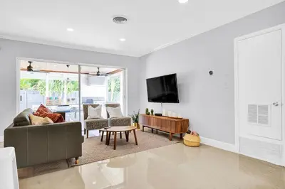 a living room with a couch and a tv on a wall at Outdoor Paradise in Fort Lauderdale