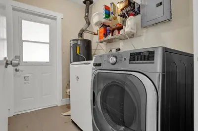 a kitchen with a washing machine in a room at Outdoor Paradise in Fort Lauderdale