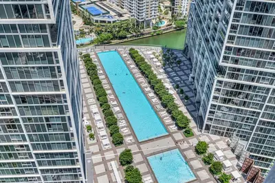 an overhead view of two swimming pools in between two buildings at Icon Luxury 34th Floor Amazing Oceanview, Brickell in Miami